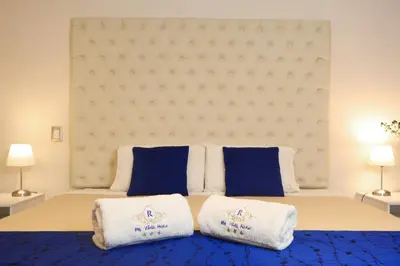 a bedroom with a bed with blue and white towels at Rig Vêda Hotel in Lima