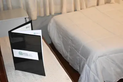 a hotel room with a bed with a sign on it at Casablanca Lima in Lima