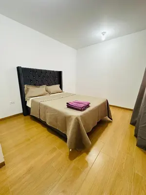 a bedroom with a bed with a blanket on it at El Oasis de Huacachina - Alojamiento in Ica