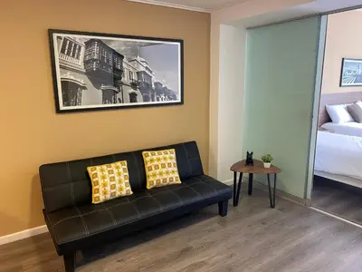 a living room with a couch and a bed at Enjoy Lima in a Renovated and Private Apt D in Lima