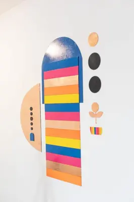 a colorful wooden skateboard with a rainbow at Solara Art House Hotel in Cusco