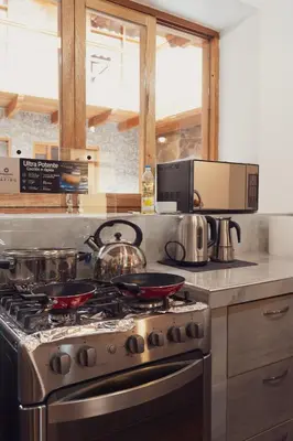 a kitchen with a stove with pots and pans at Casa Alba Ollantaytambo in Ollantaytambo