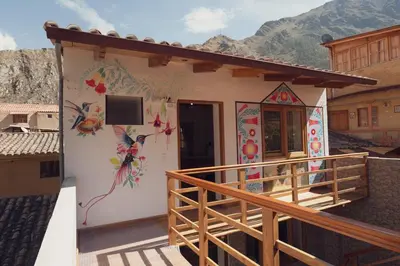 a house with paintings on the side of it at Casa Alba Ollantaytambo in Ollantaytambo