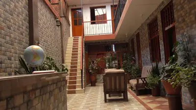 a hallway of a building with plants in it at IntiKilla in Mollepata