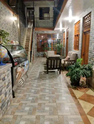 a hallway of a building with a staircase and a table at IntiKilla in Mollepata