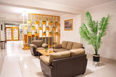 a living room with two couches and a table at Hostal Los Balcones II in Nazca