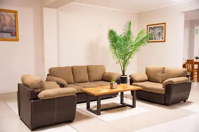 a living room with two couches and a coffee table at Hostal Los Balcones II in Nazca