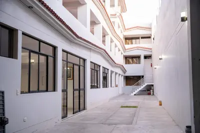 an empty hallway of an apartment building with windows at Hostal Los Balcones II in Nazca