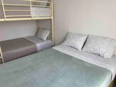 a room with two bunk beds and a bed at Casa de Campo en Cieneguilla in Hacienda Cienguilla