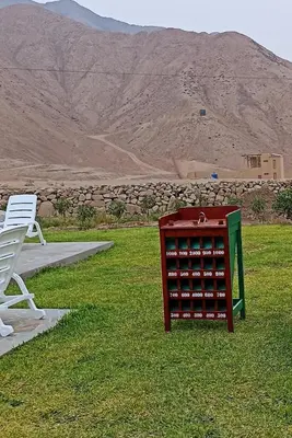 a table and two chairs sitting in the grass at Casa de Campo en Cieneguilla in Hacienda Cienguilla