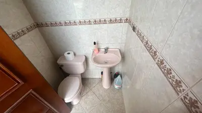 a small bathroom with a toilet and a sink at Casa Grande de Campo en Huachipa in Lima