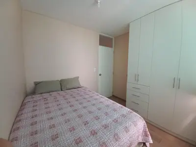 a bedroom with a bed and white cabinets at Casa Linda San Miguel in Lima