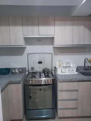 a kitchen with a stove and a sink at Casa Linda San Miguel in Lima