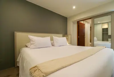 a bedroom with a large bed with white pillows at Mimosas 161 by Wynwood House in Lima