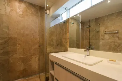 a bathroom with a sink and a shower at Mimosas 161 by Wynwood House in Lima