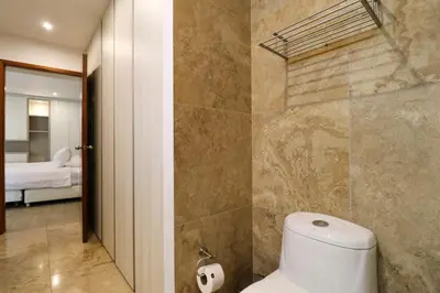 a bathroom with a toilet and a bedroom at Mimosas 161 by Wynwood House in Lima