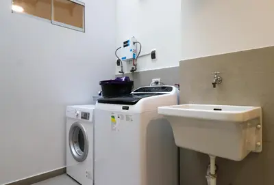a laundry room with a washing machine and a sink at Mimosas 161 by Wynwood House in Lima