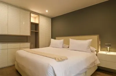 a bedroom with a large bed with white sheets and pillows at Mimosas 161 by Wynwood House in Lima