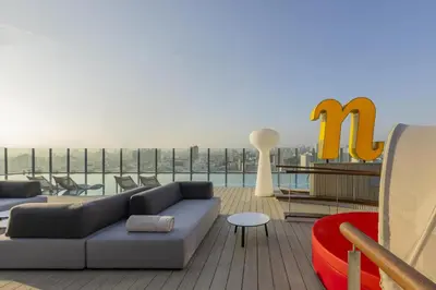 a living room with a couch and chairs on a roof at Nhow Lima in Lima