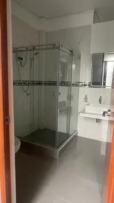 a glass shower in a bathroom with a sink at Casa de Campo Aucallama in Huaral