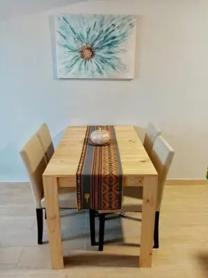 a wooden dining table with two chairs at Bonito y Moderno 1 o 2 dormitorios in Lima