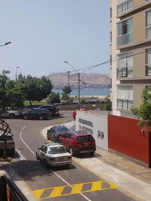 a parking lot with cars parked next to a building at Fantastic Location in Miraflores in Perú in Lima