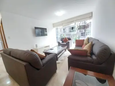 a living room with two couches and a coffee table at Fantastic Location in Miraflores in Perú in Lima