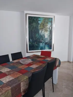 a room with a table and a painting on the wall at Fantastic Location in Miraflores in Perú in Lima