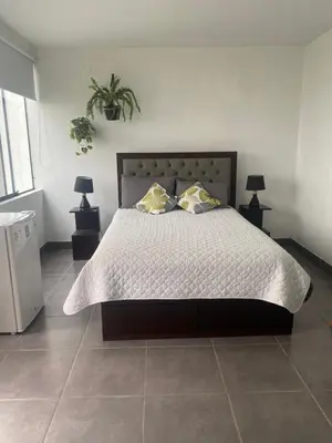 a bedroom with a large bed with two pillows at Hermosa habitación independiente cerca a Miraflores in Lima