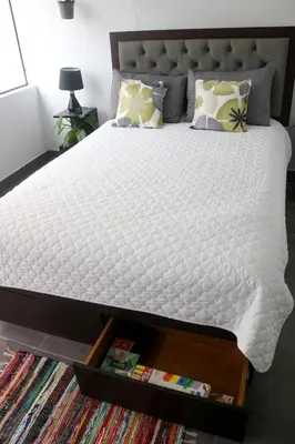 a bedroom with a bed with a white mattress at Hermosa habitación independiente cerca a Miraflores in Lima