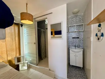 a small bathroom with a sink and a mirror at Surfer Hostel El Quilla Punta Hermosa in Punta Hermosa