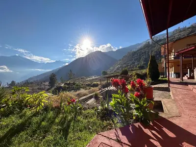 a view of a mountain with flowers in the foreground at CASA de SALCANTAY , Choquequirao in Cachora