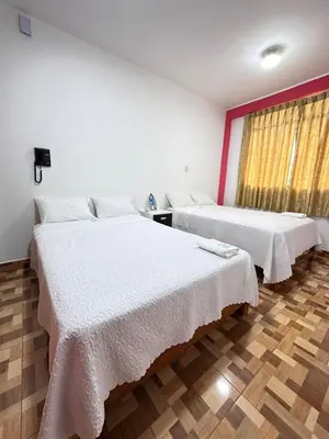 a room with two beds and a window at Hotel Atenas City in San Andrés