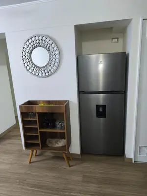 a kitchen with a stainless steel refrigerator in a room at Adriane in Lima
