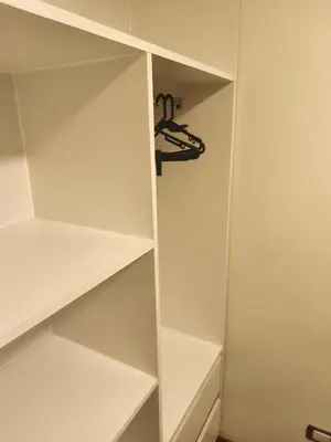 a walk in closet with white shelves at Adriane in Lima