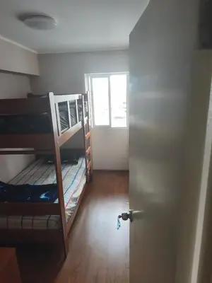 a room with two bunk beds and a door at Adriane in Lima
