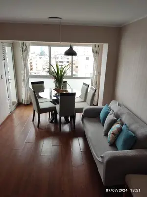 a living room with a couch and a table at Adriane in Lima