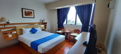 a bedroom with a bed and a table and a window at Blue Star Hotel in Lima
