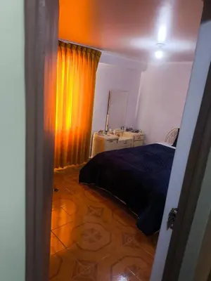 a bedroom with a bed and a dresser and a mirror at Aqquazul Hospedaje Ayacucho in Ayacucho