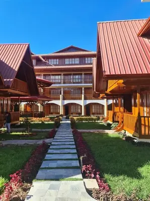 a building with a pathway in front of it at DCampos Lodge in Oxapampa
