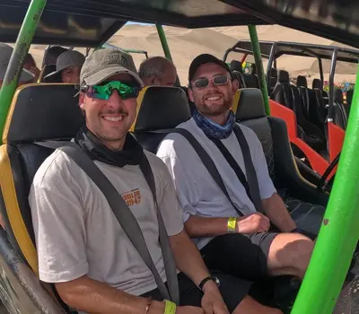 two men sitting in the back of a bus at Adanny Tours Peru in Lima