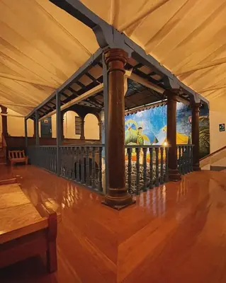 a balcony with a mural of a train on the wall at Rojas Plaza Boutique in Cusco