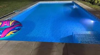 a swimming pool with a beach ball in the water at Casa de campo en Condominio in San Vicente de Cañete