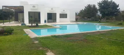 a swimming pool in the yard of a house at Casa de campo en Condominio in San Vicente de Cañete
