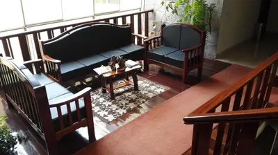 a balcony with two chairs and a couch and a table at Hotel Rivera in Ayacucho