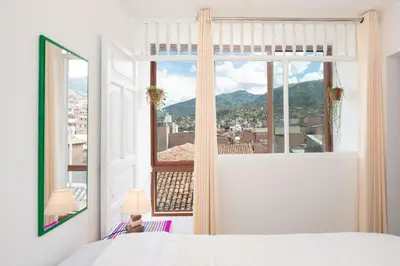 a bedroom with a large window with a view at Retablo Boutique Hotel in Ayacucho