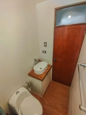 a small bathroom with a toilet and a sink at Cusco Central Complete Apartment in Cusco