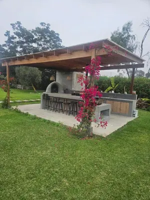 a picnic shelter with a grill in a park at Alquiler Casa de Campo Asia Cañete in San Andrés