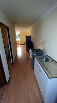 a kitchen with a sink and a stove in a room at Departamento Centro Financiero San isidro in Lima