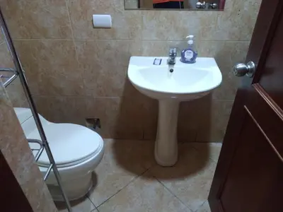 a bathroom with a white sink and a toilet at Departamento Centro Financiero San isidro in Lima